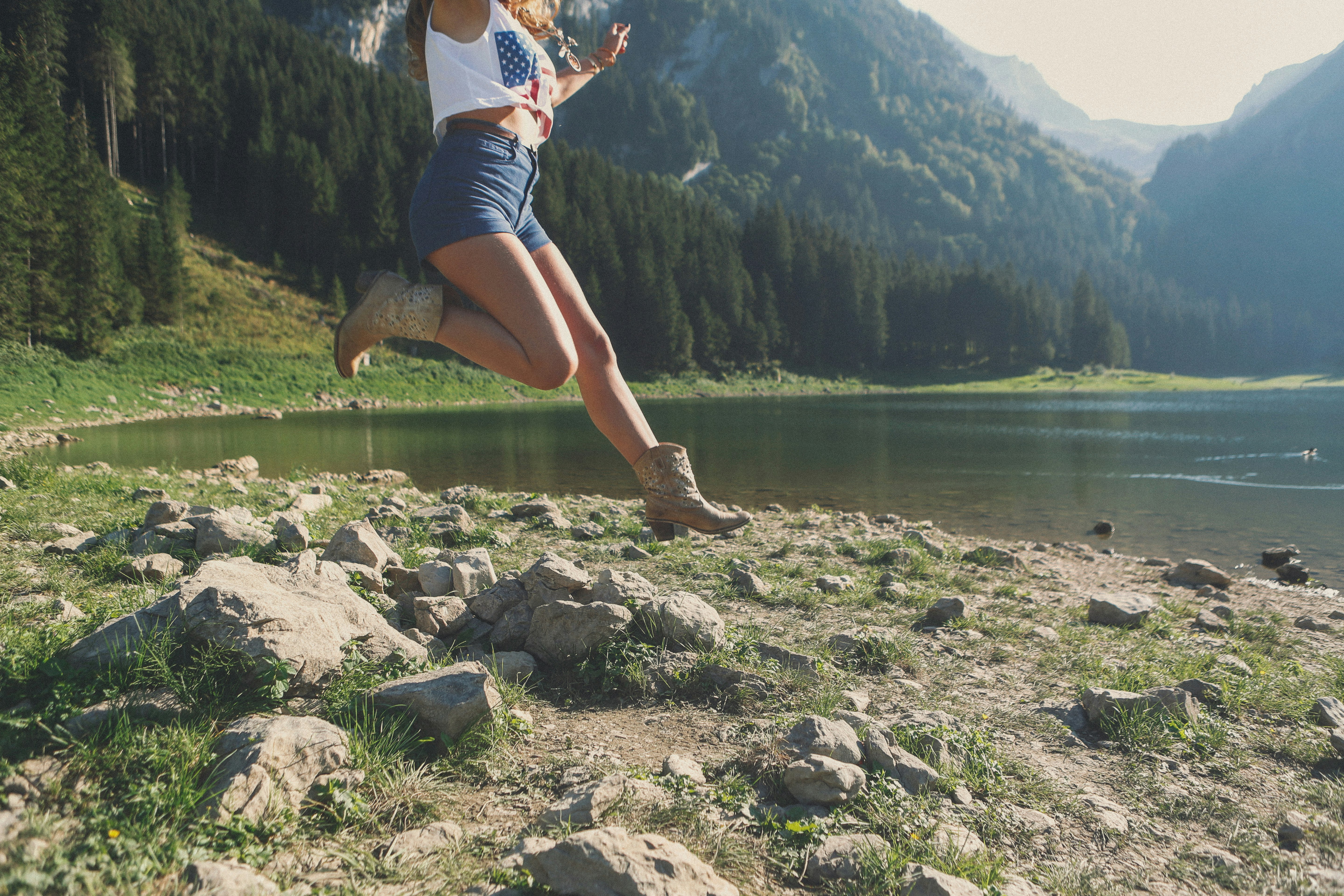 woman jumping near river